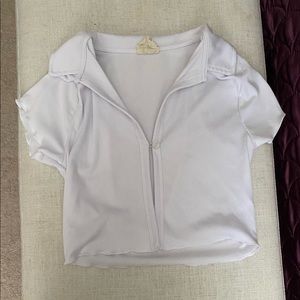 a white shirt with a button in the middle